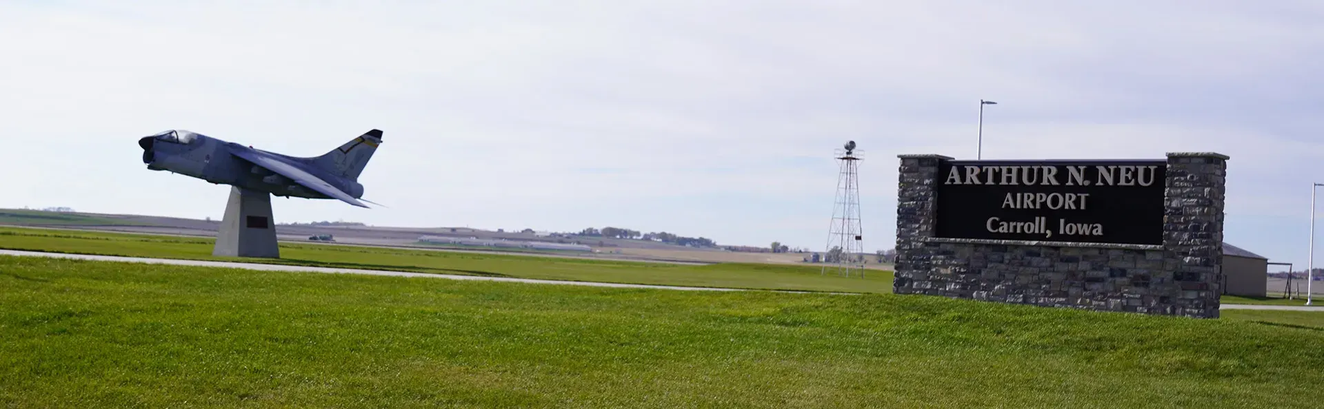 Large sign at Carroll, IA airport with jet.